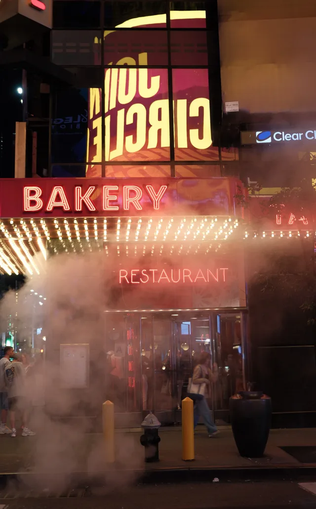 Steam drifts across a brightly lit bakery frontage.