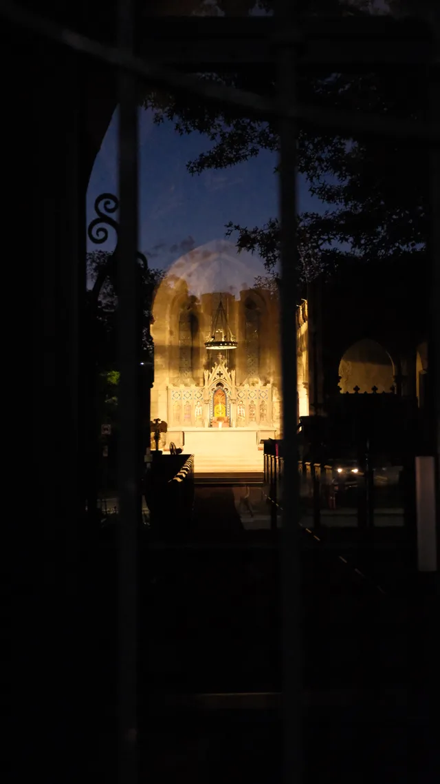 A warm illuminated interior appears through a shadowed doorway.